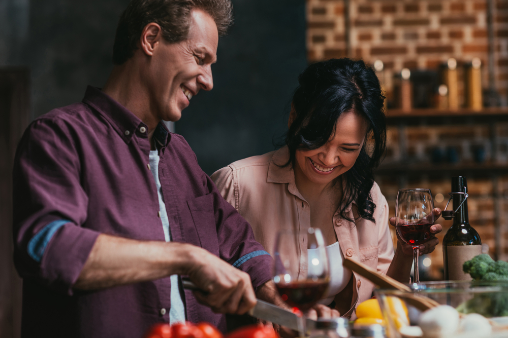 Man and woman smiling and drinking wine, which may affect his libido in Los Angeles, CA